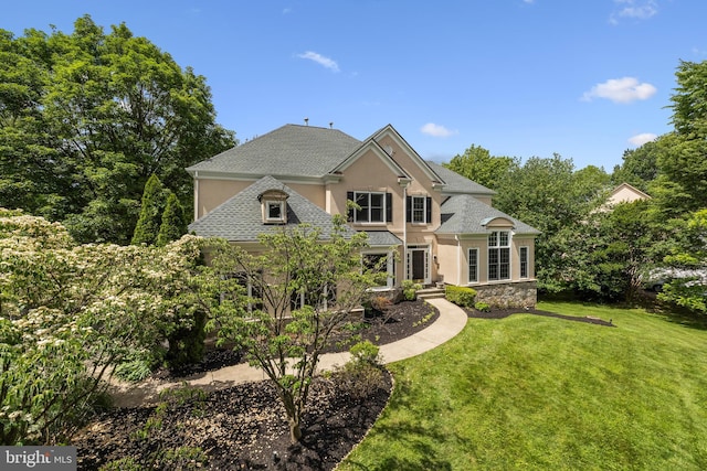 1418 Woodhurst Blvd, Mclean, VA 22102 - view of front facade featuring stucco siding, a front yard, and a shingled roof