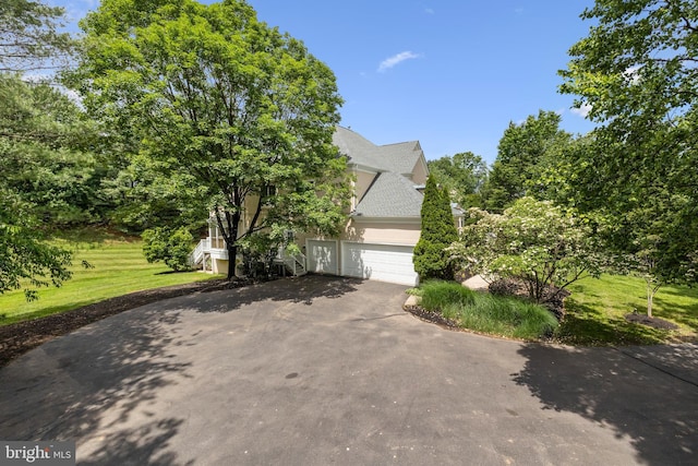 1418 Woodhurst Blvd, Mclean, VA 22102 - view of property exterior with asphalt driveway, stucco siding, a yard, and roof with shingles