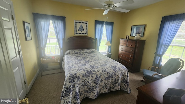 bedroom with baseboards, a ceiling fan, and carpet