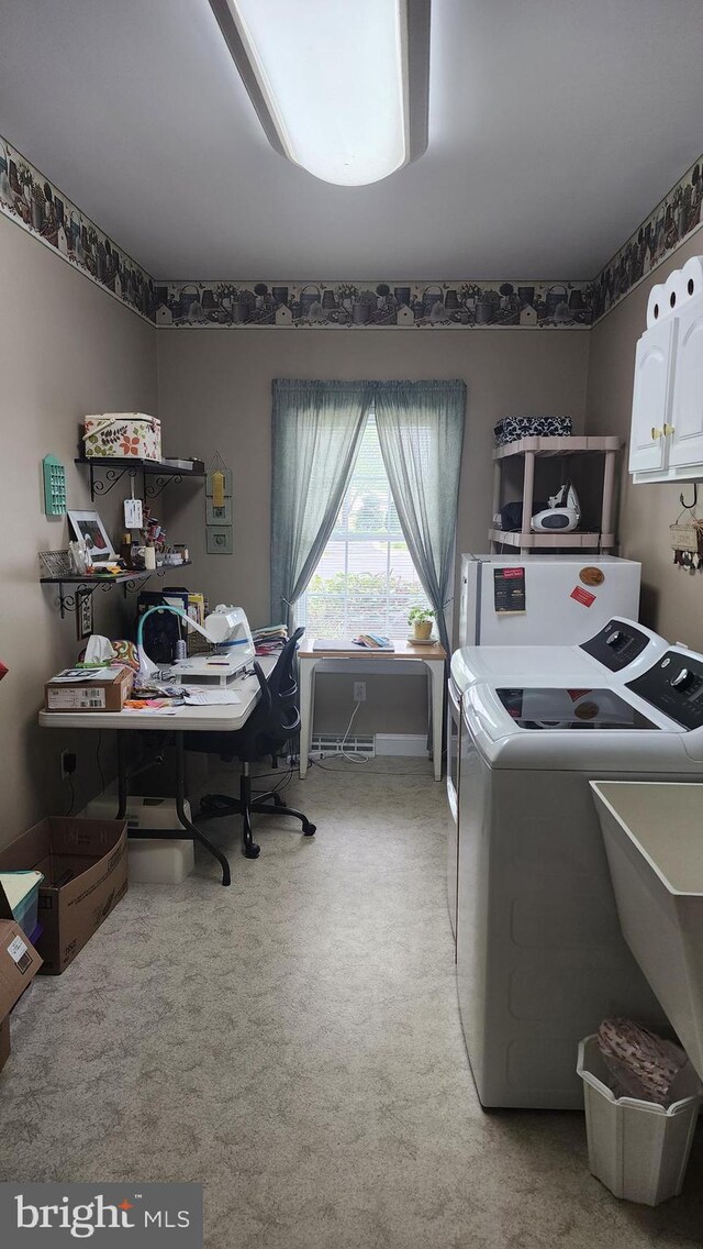 interior space with a sink, independent washer and dryer, and light carpet