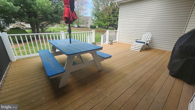deck featuring a lawn and outdoor dining space