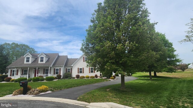 cape cod house with a porch and a front lawn