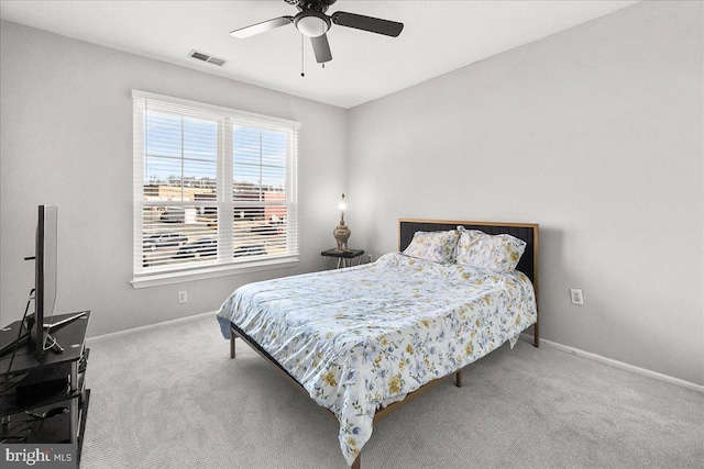 bedroom with carpet flooring, visible vents, ceiling fan, and baseboards
