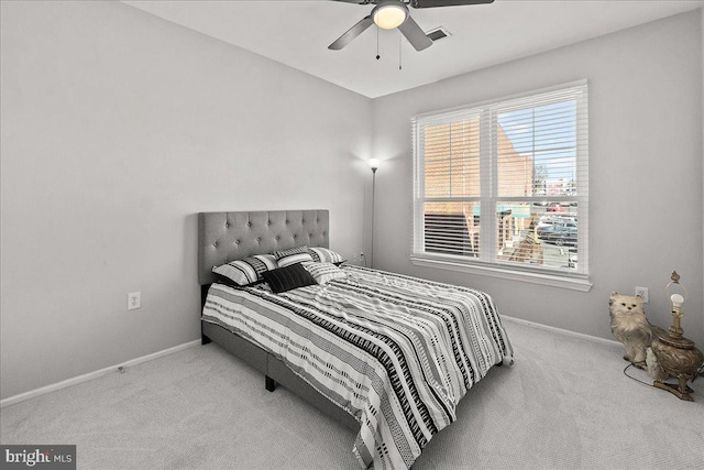 carpeted bedroom featuring visible vents, a ceiling fan, and baseboards