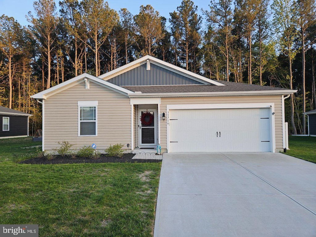 ranch-style home featuring concrete driveway, a front yard, board and batten siding, and a garage