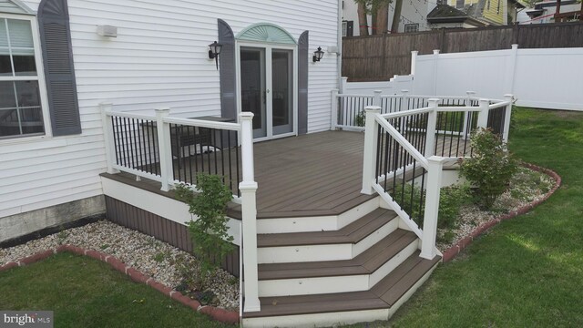 wooden terrace featuring fence