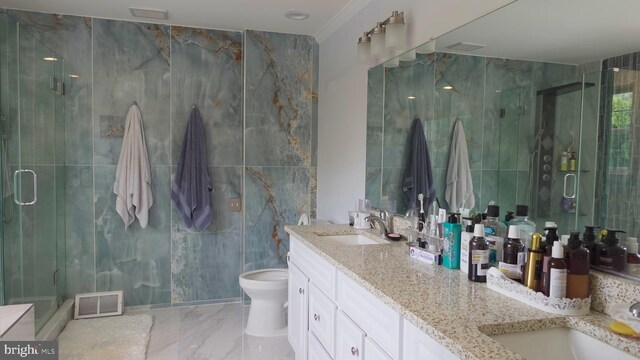 bathroom with a stall shower, tile walls, a sink, and marble finish floor