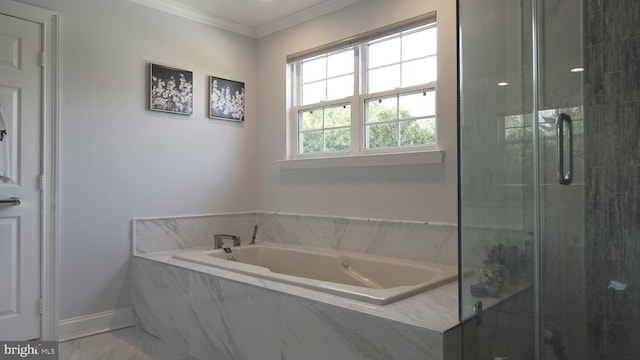 full bathroom featuring a garden tub, a stall shower, crown molding, and baseboards