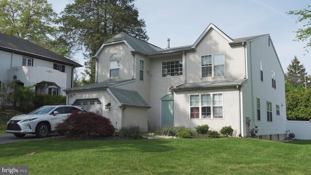 view of front of house featuring a front lawn and stucco siding