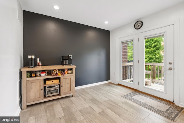 bar featuring light wood-type flooring, baseboards, and recessed lighting