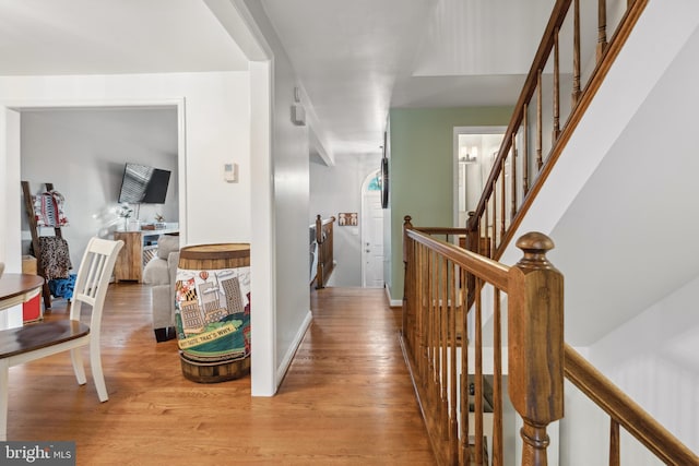 hallway with light wood-style flooring and stairs