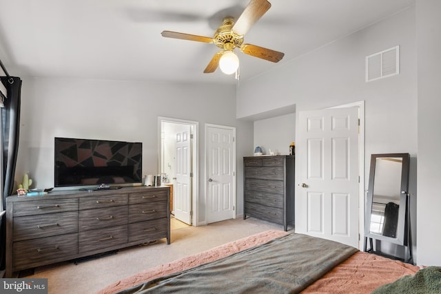 bedroom with light colored carpet, lofted ceiling, ensuite bath, and ceiling fan