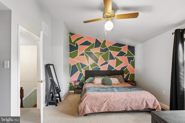 carpeted bedroom with ceiling fan and baseboards
