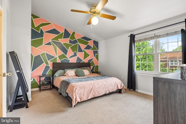 carpeted bedroom featuring baseboards and a ceiling fan