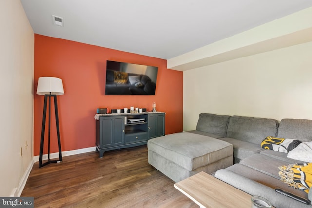 living area featuring dark wood-style floors and baseboards