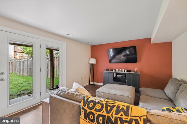 living area with wood finished floors and baseboards