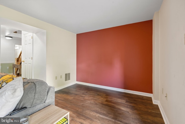 unfurnished room featuring wood finished floors and baseboards