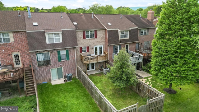rear view of house featuring roof with shingles, stairway, cooling unit, and brick siding