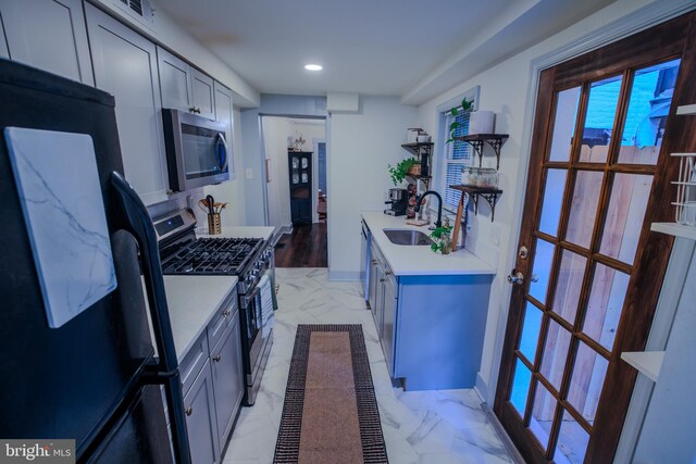 623 Marietta Ave, Lancaster, PA 17603 - kitchen with appliances with stainless steel finishes, a sink, light marble finish floors, light countertops, and recessed lighting