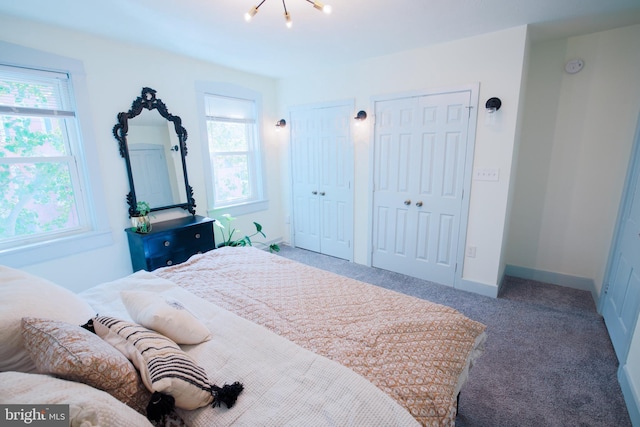 623 Marietta Ave, Lancaster, PA 17603 - bedroom with multiple windows, two closets, carpet, and a chandelier