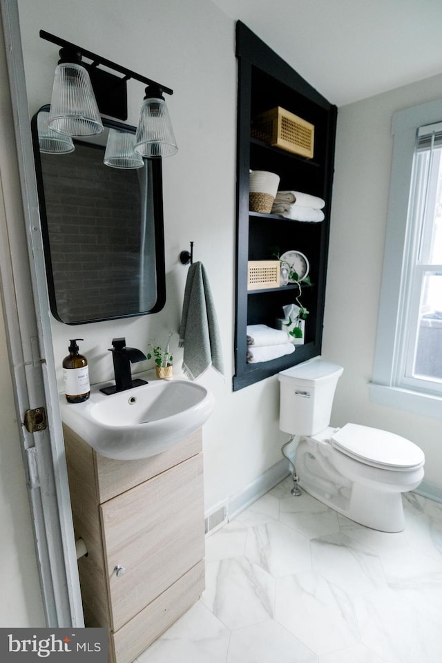 623 Marietta Ave, Lancaster, PA 17603 - half bath featuring vanity, marble finish floors, toilet, and baseboards