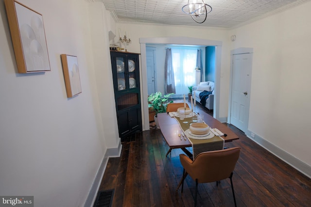 623 Marietta Ave, Lancaster, PA 17603 - dining room with ornamental molding, baseboards, hardwood / wood-style flooring, and a chandelier