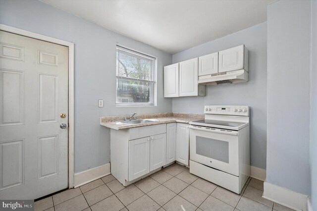 kitchen with white cabinetry, electric range, under cabinet range hood, a sink, and baseboards