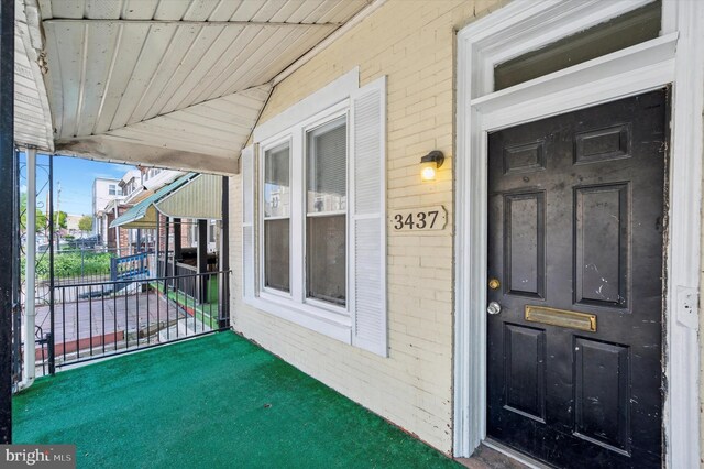 property entrance featuring brick siding