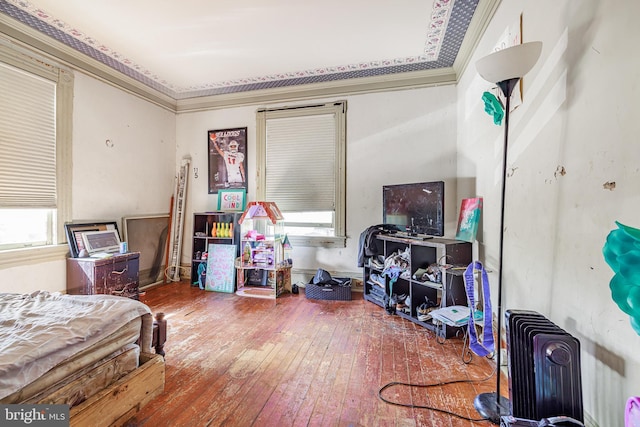 bedroom with crown molding and hardwood / wood-style floors