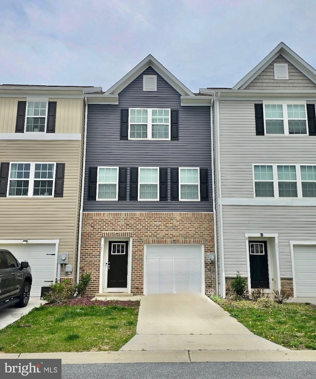 townhome / multi-family property featuring brick siding, driveway, and a garage