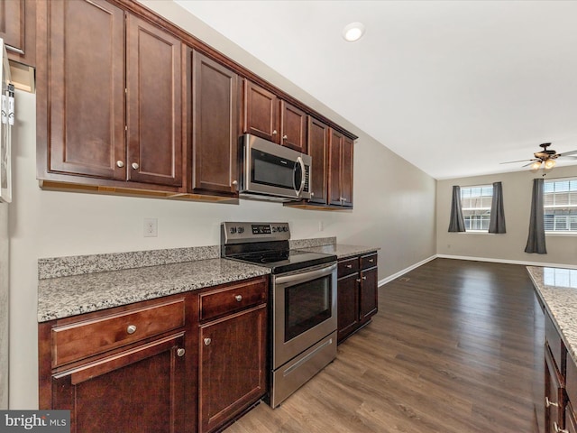 kitchen with stainless steel appliances, baseboards, a ceiling fan, open floor plan, and wood finished floors