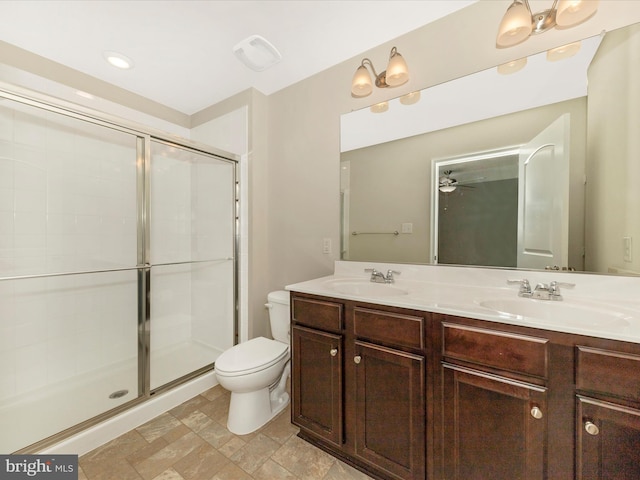 full bath featuring toilet, a shower stall, and a sink