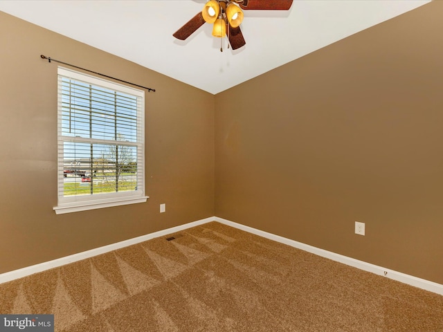 carpeted spare room with baseboards and ceiling fan