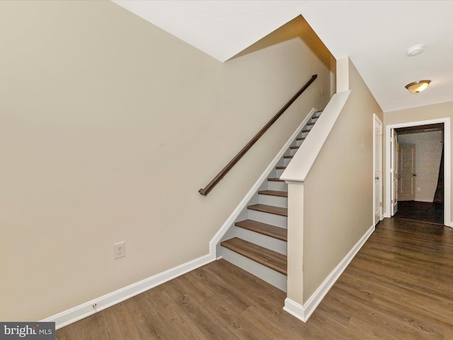 stairs featuring baseboards and wood finished floors