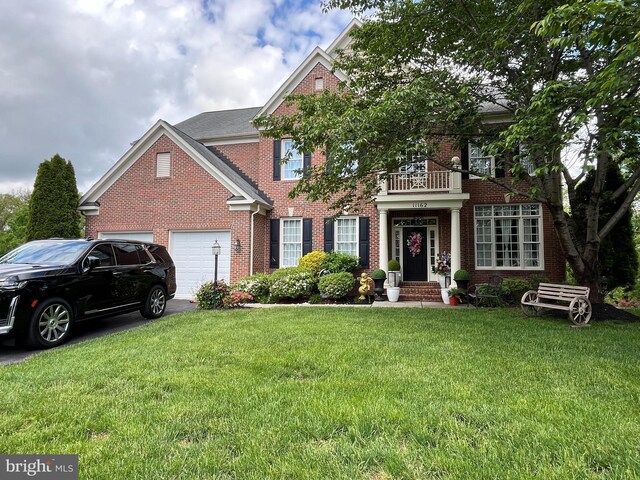 11162 Innsbrook Ct, Ijamsville, MD 21754 - colonial inspired home with brick siding, a garage, a front yard, a balcony, and driveway