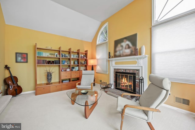 living area with carpet flooring, a fireplace, visible vents, vaulted ceiling, and baseboards