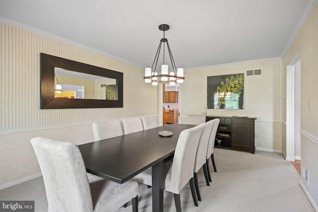 dining room featuring a notable chandelier, visible vents, light carpet, ornamental molding, and wallpapered walls