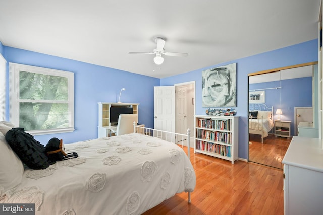 bedroom with light wood finished floors and a ceiling fan