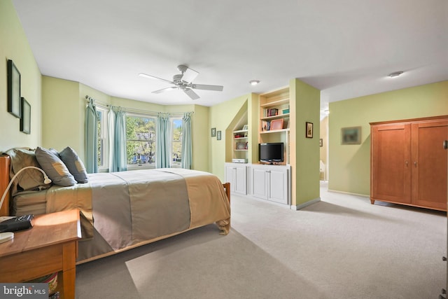 bedroom featuring baseboards, light carpet, and ceiling fan