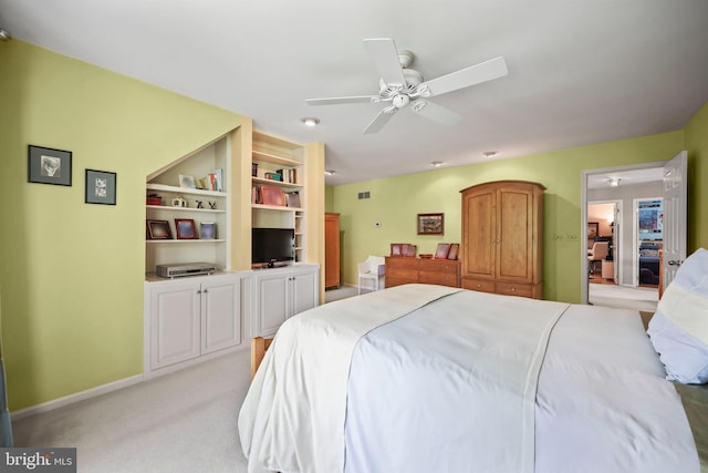 bedroom featuring a ceiling fan, visible vents, light colored carpet, and baseboards