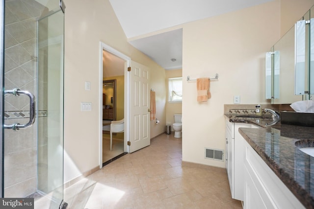 bathroom with a sink, double vanity, visible vents, a stall shower, and toilet