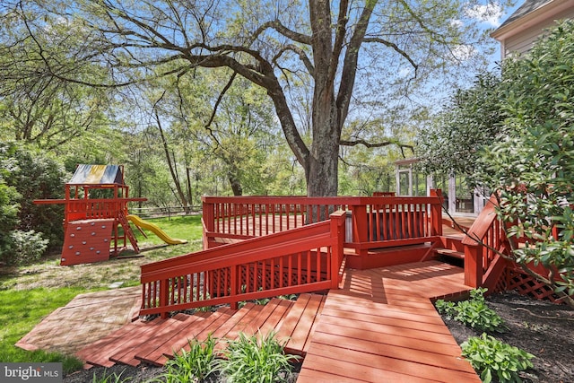 deck featuring a playground and fence