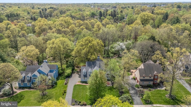 birds eye view of property featuring a wooded view