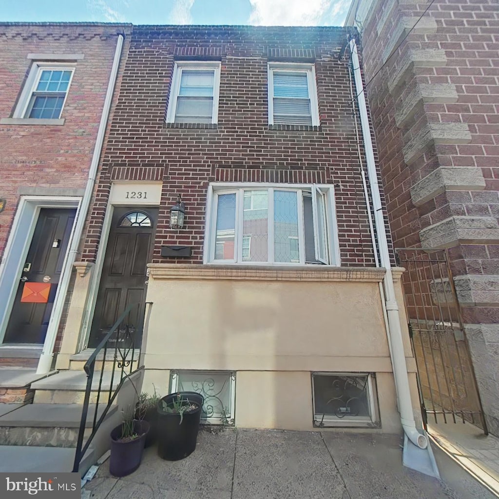 view of property featuring brick siding