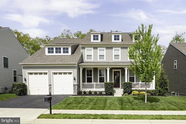 view of front of home featuring a porch, driveway, roof with shingles, and a front lawn