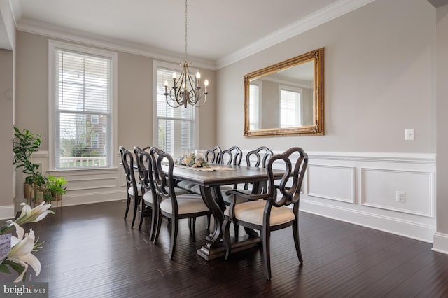 dining space with dark wood-style flooring, an inviting chandelier, plenty of natural light, and a decorative wall