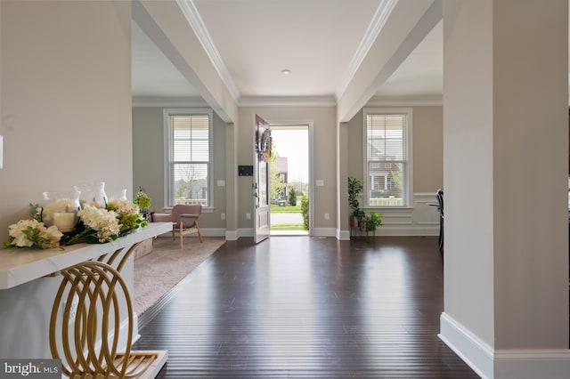 foyer entrance featuring baseboards, dark wood finished floors, and ornamental molding