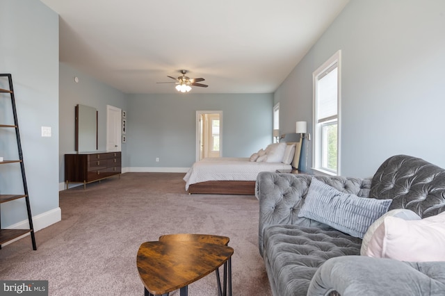 bedroom featuring carpet floors, baseboards, ceiling fan, and multiple windows