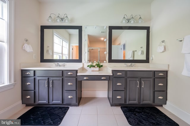 bathroom featuring double vanity, a sink, and tile patterned flooring