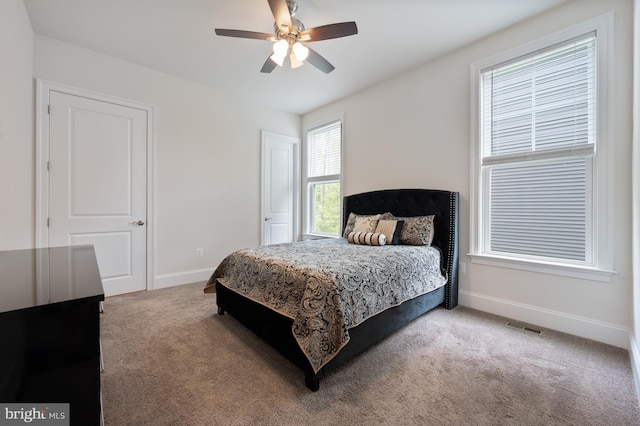 bedroom with visible vents, carpet flooring, baseboards, and ceiling fan